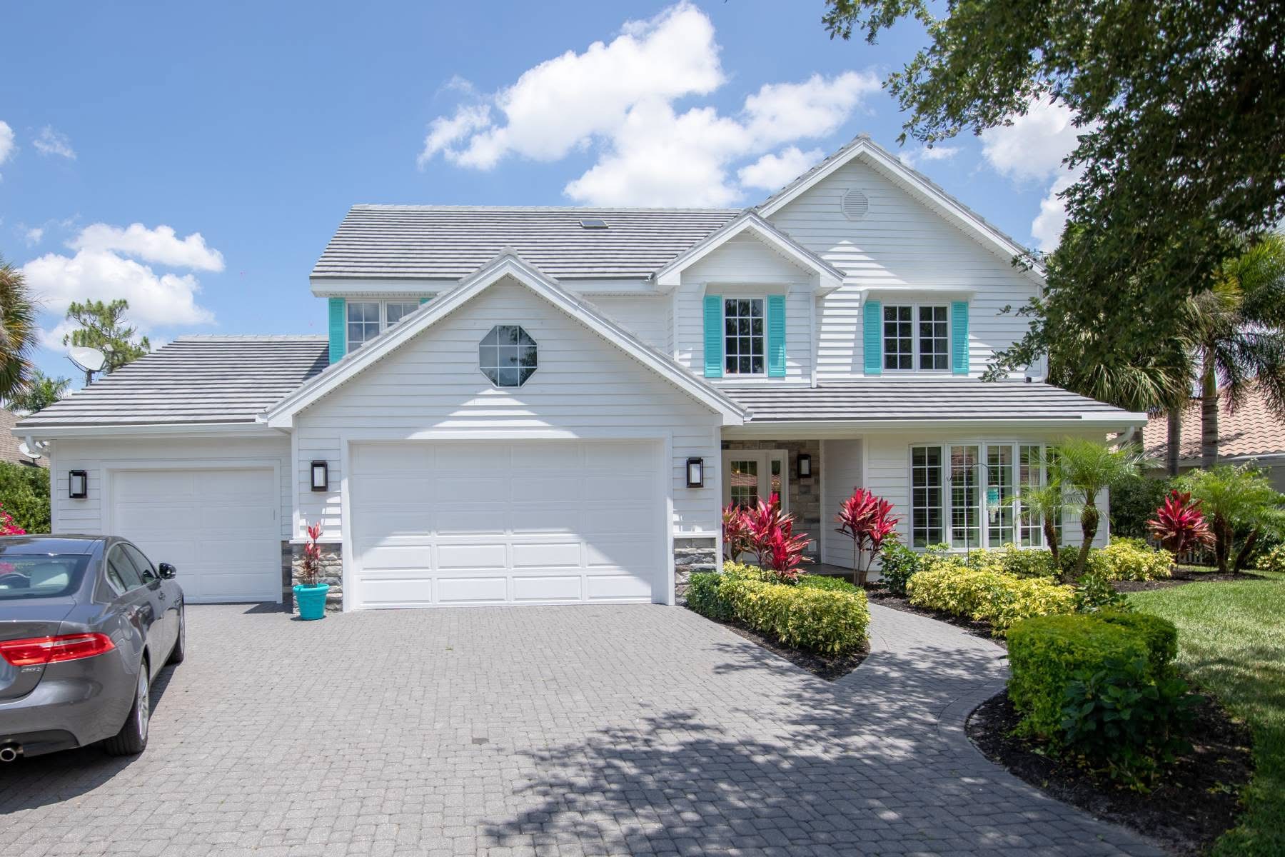 Two story home with grey tile roof