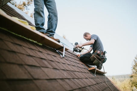 contractors repairing a roof